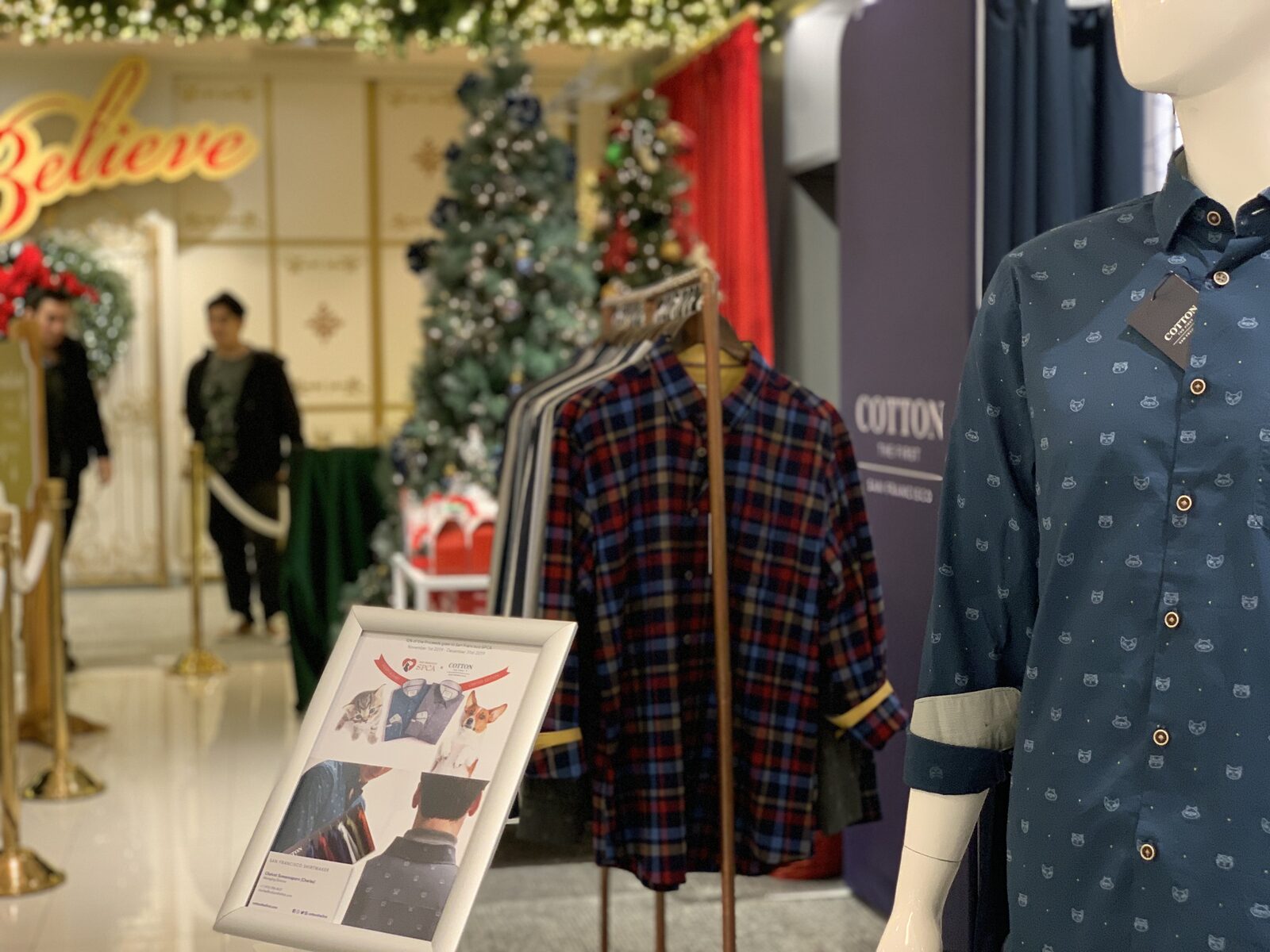Cotton the First display at Macy's — mannequin wearing SPCA capsule shirt with holiday decor