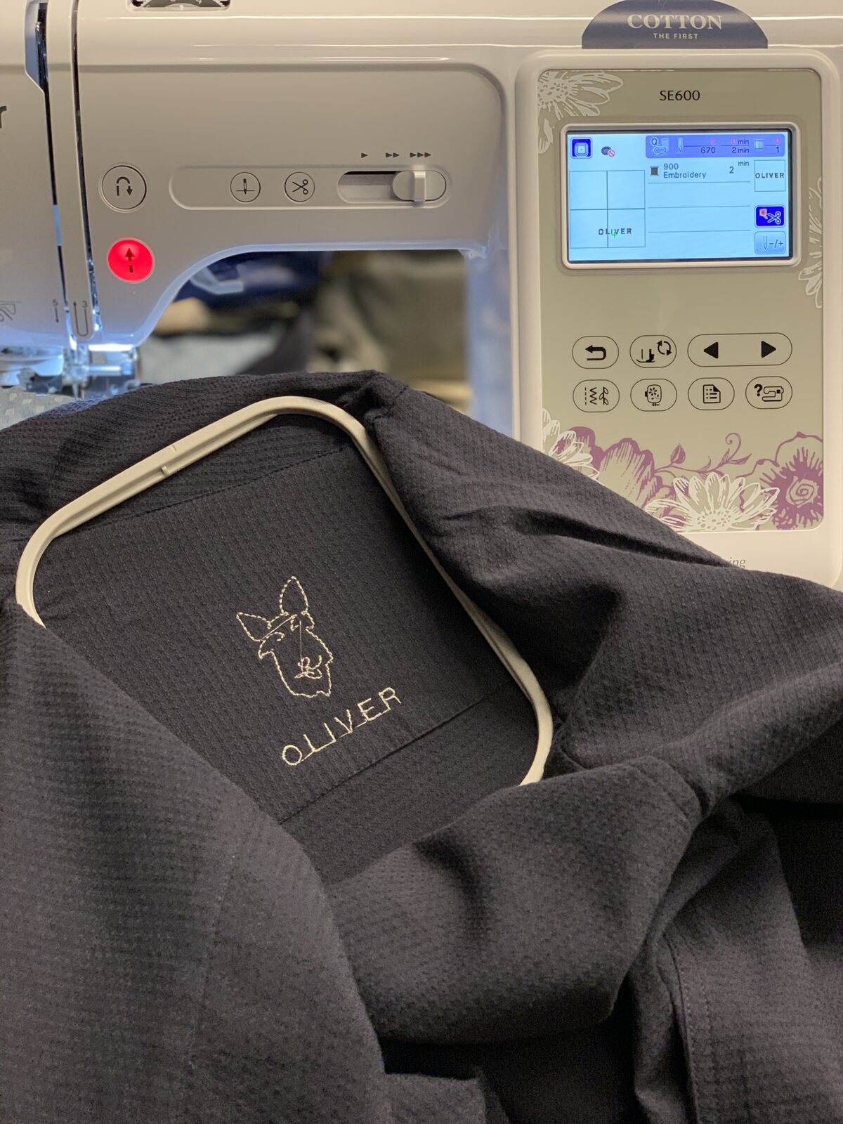 Embroidery machine stitching Oliver the Chihuahua onto a shirt